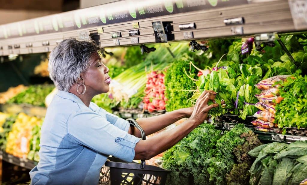 african american woman shopping for vegetables integrated health