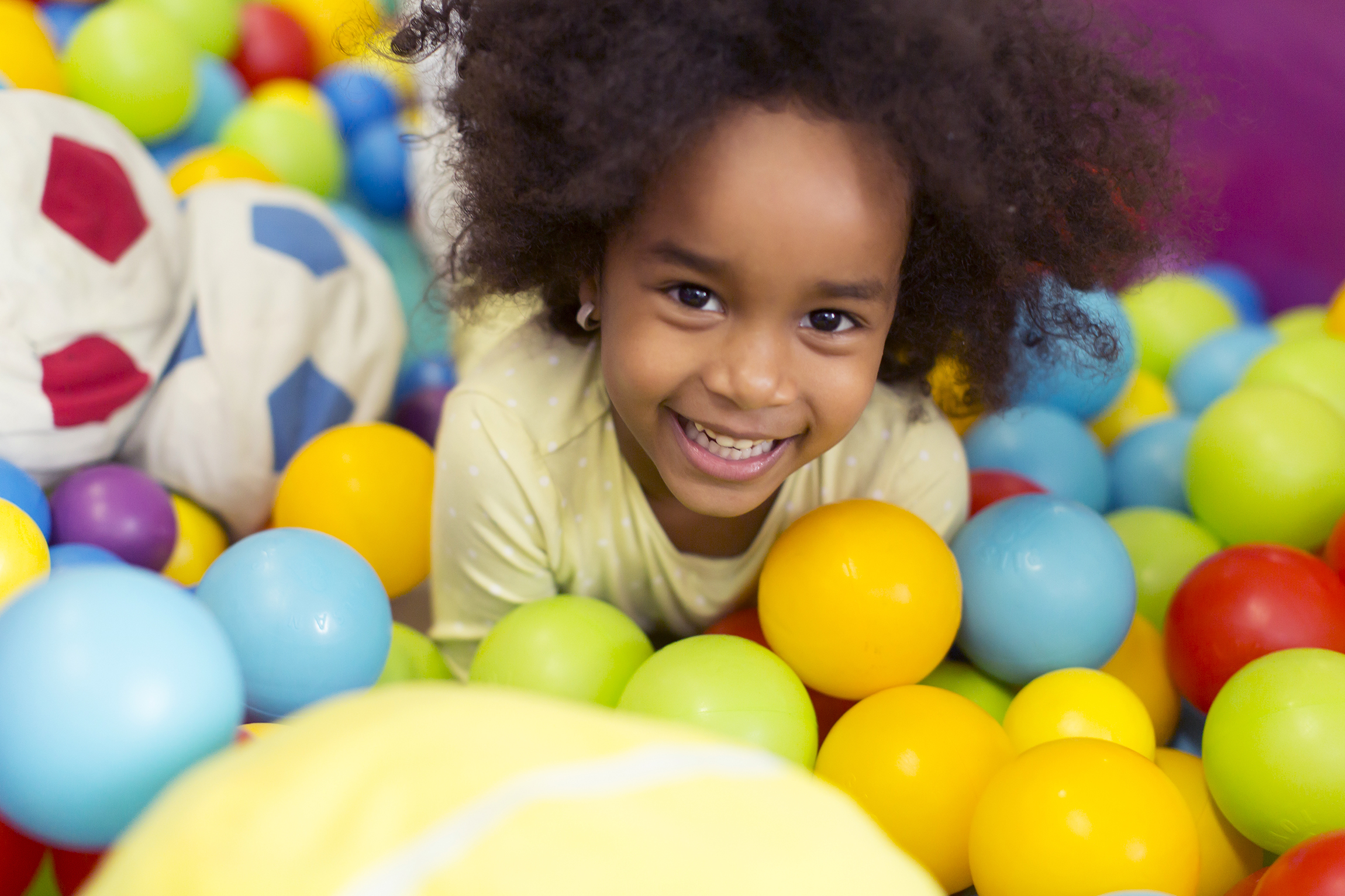 black Child Playing with coloredBalls
