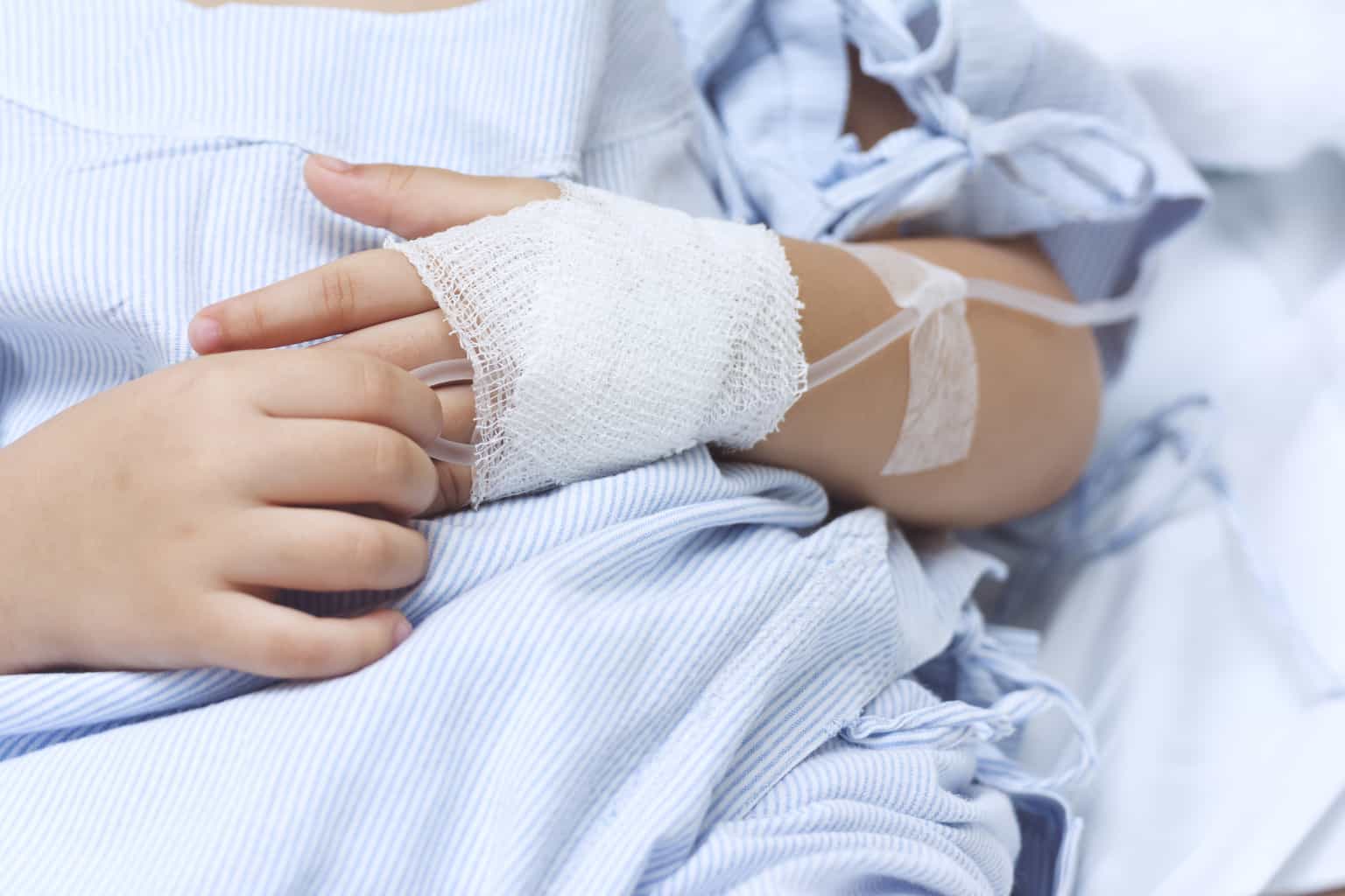 child with bandages and iv on hand who experienced what is frostbite at the hennepin county burn center where they treat scalds,