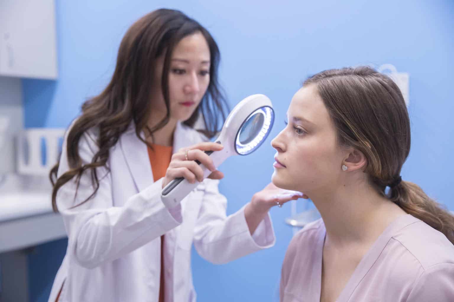 skin care doctor dermatologist assesses patient at clinics in dermatology