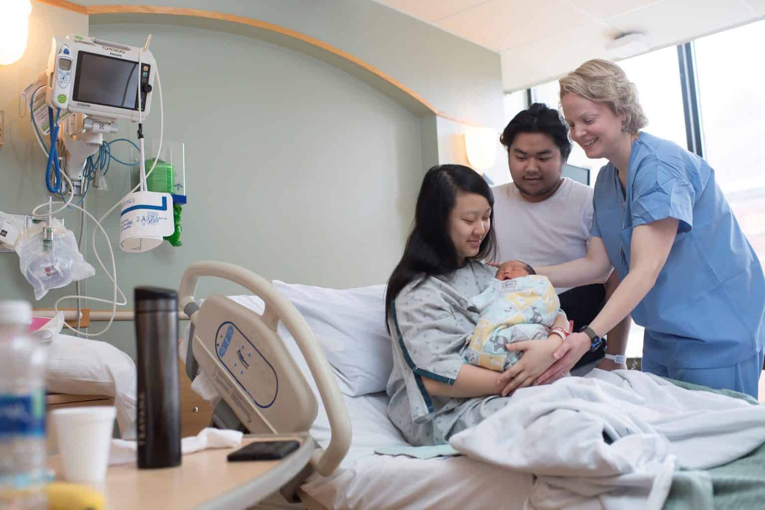 midwife with young couple and newborn baby, midwife center minneapolis, midwife clinic, midwife nurse
