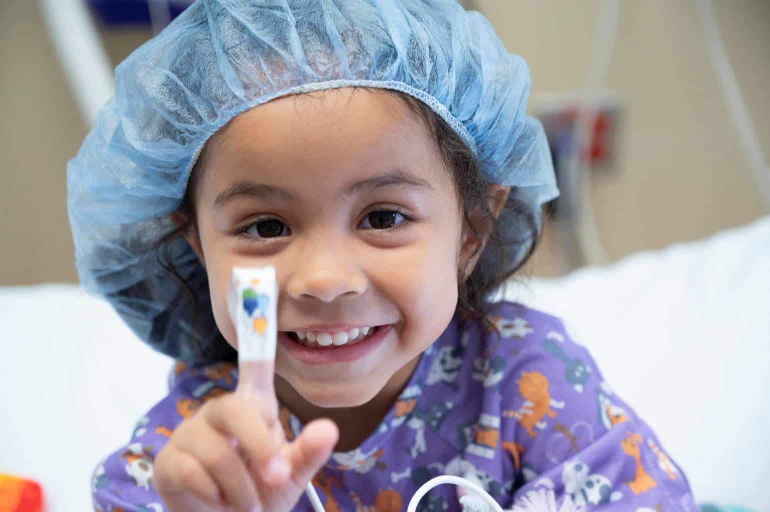 girl with bandaid and surgery hair net and gown
