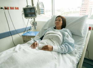 woman in hospital bed waiting for colon surgery, colon & rectal surgeons, colon and rectal surgeon, colon and rectal surgery, anus surgery, proctologist exam