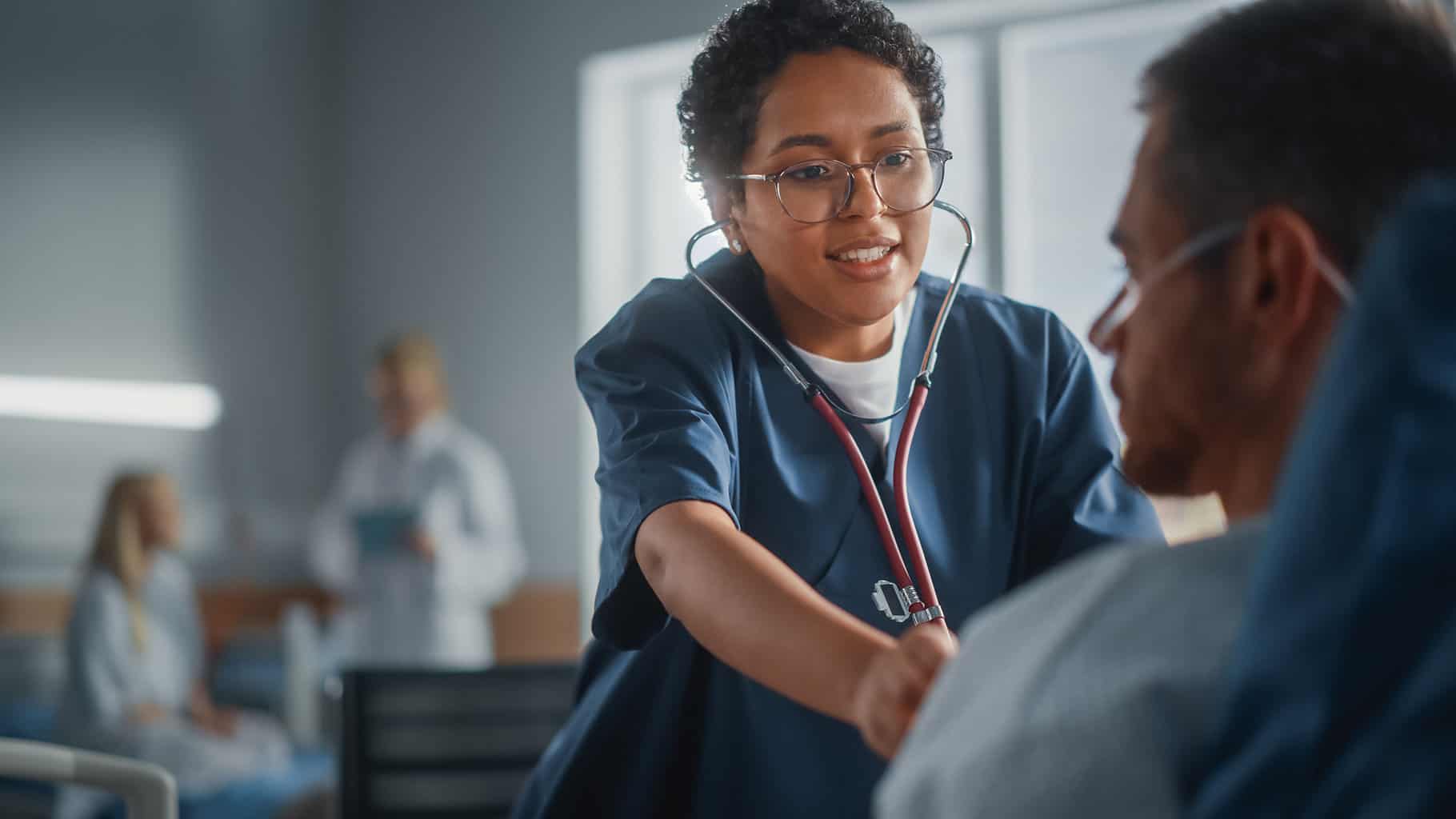 Black Nurse using stethoscope to listen to patient's lungs in hospital ward, lung clinic, lung cancer, pulmonary specialty, pulmonary clinics, mn lung
