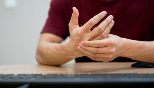 Close Up Freelancer Man Use Hand To Massage For Relief Pain From Hard Working At Office Table ,carpal Tunnel Syndrome Concept, hand conditions, hand pain treatment, carpal tunnel, metacarpal fracture symptoms, broken finger, broken wrist