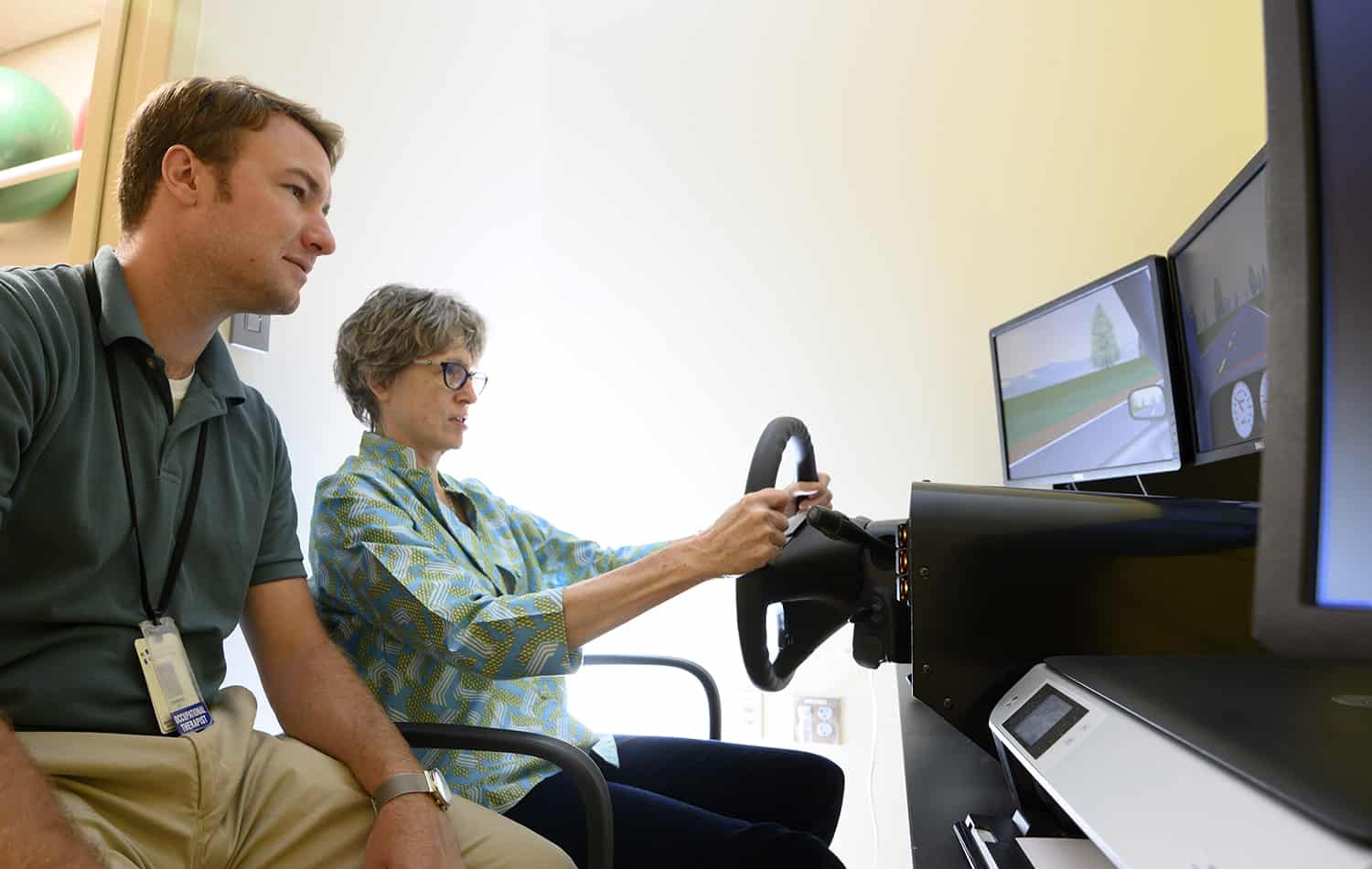 tbi therapist with patient and drive simulator