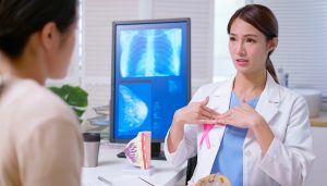 oncology doctor describing breast reconstruction to patient, tissue expander problems, tissue expanders problems, replacing tissue expanders with implants recovery, breast reconstruction, breast rehab, breast rehabilitation