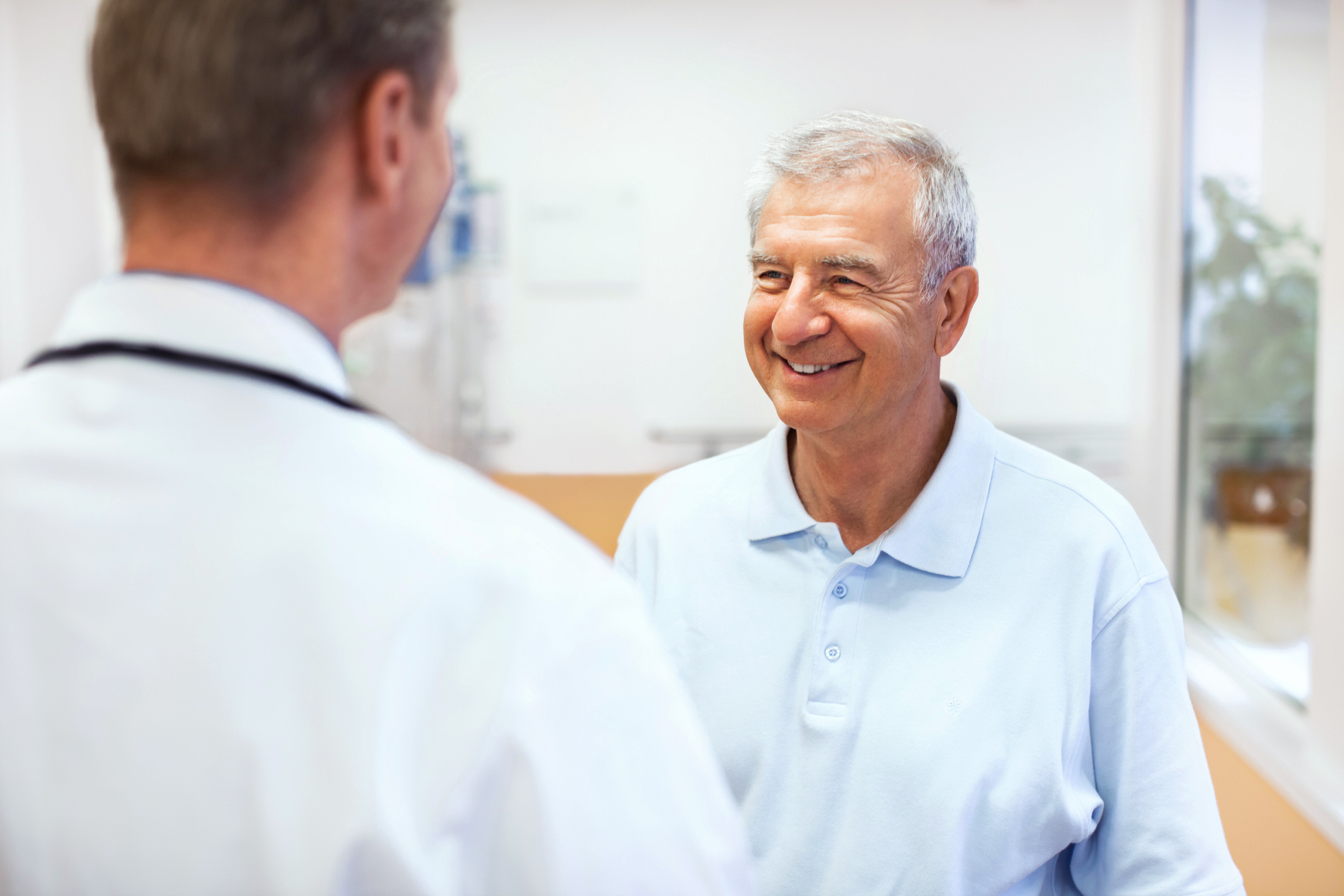 older man consulting with doctor about urine incontinence, types of incontinence, urine leakage, leakage urine, causes of incontinence