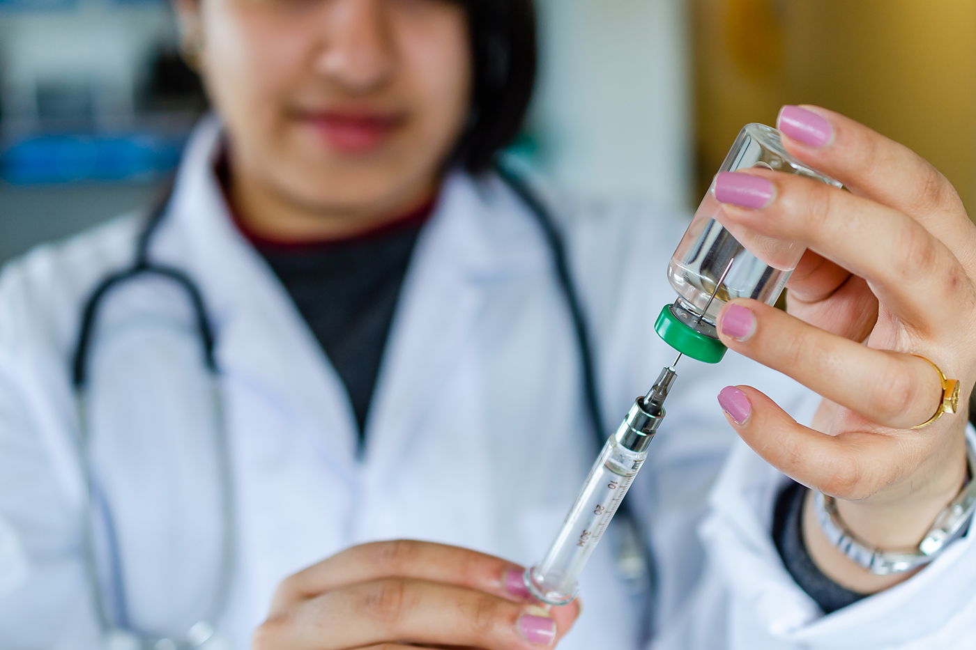 nurse with a vaccine needle