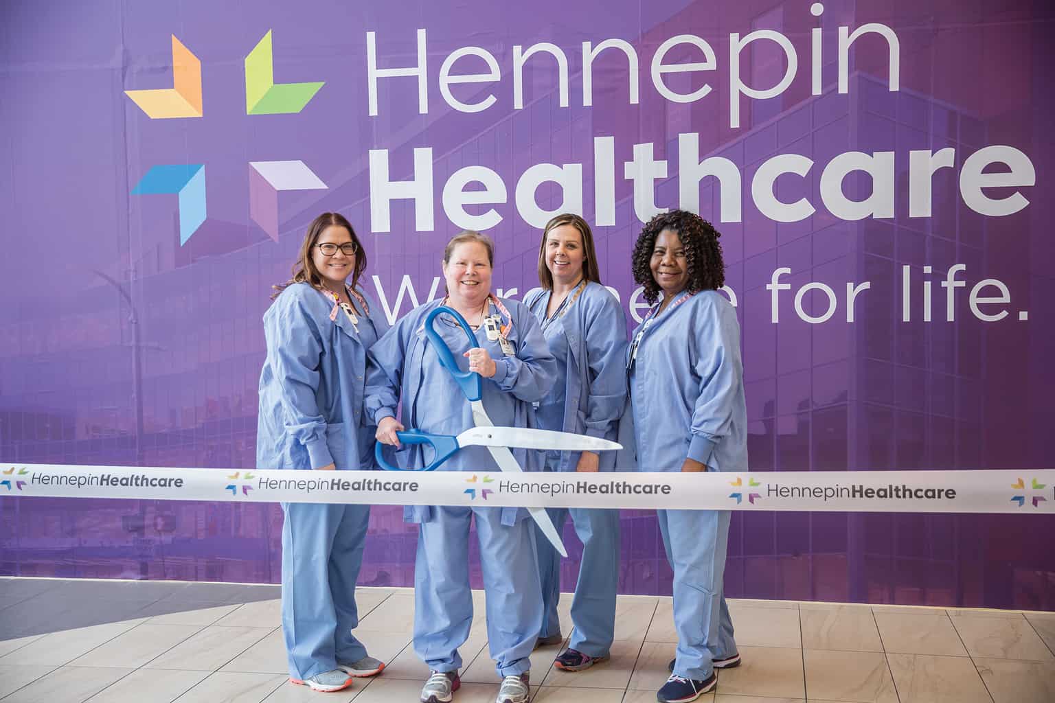 staff with hennepin healthcare branding wall ribbon cutting, mersc discounts, medica reimbursement account, healthcare benefits for employees, healthcare employee benefits, medica my health rewards