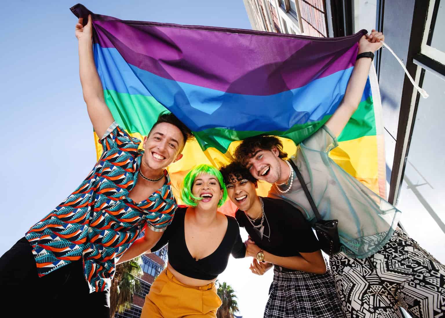 Young Group holding up pride flag during Parade