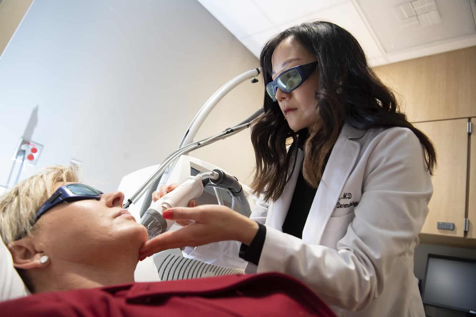 center for cosmetic dermatology dermatologist talks with patient about dermatology procedures