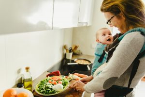 mom with baby preparing meal