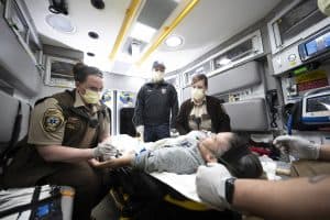 paramedics with patient in ambulance