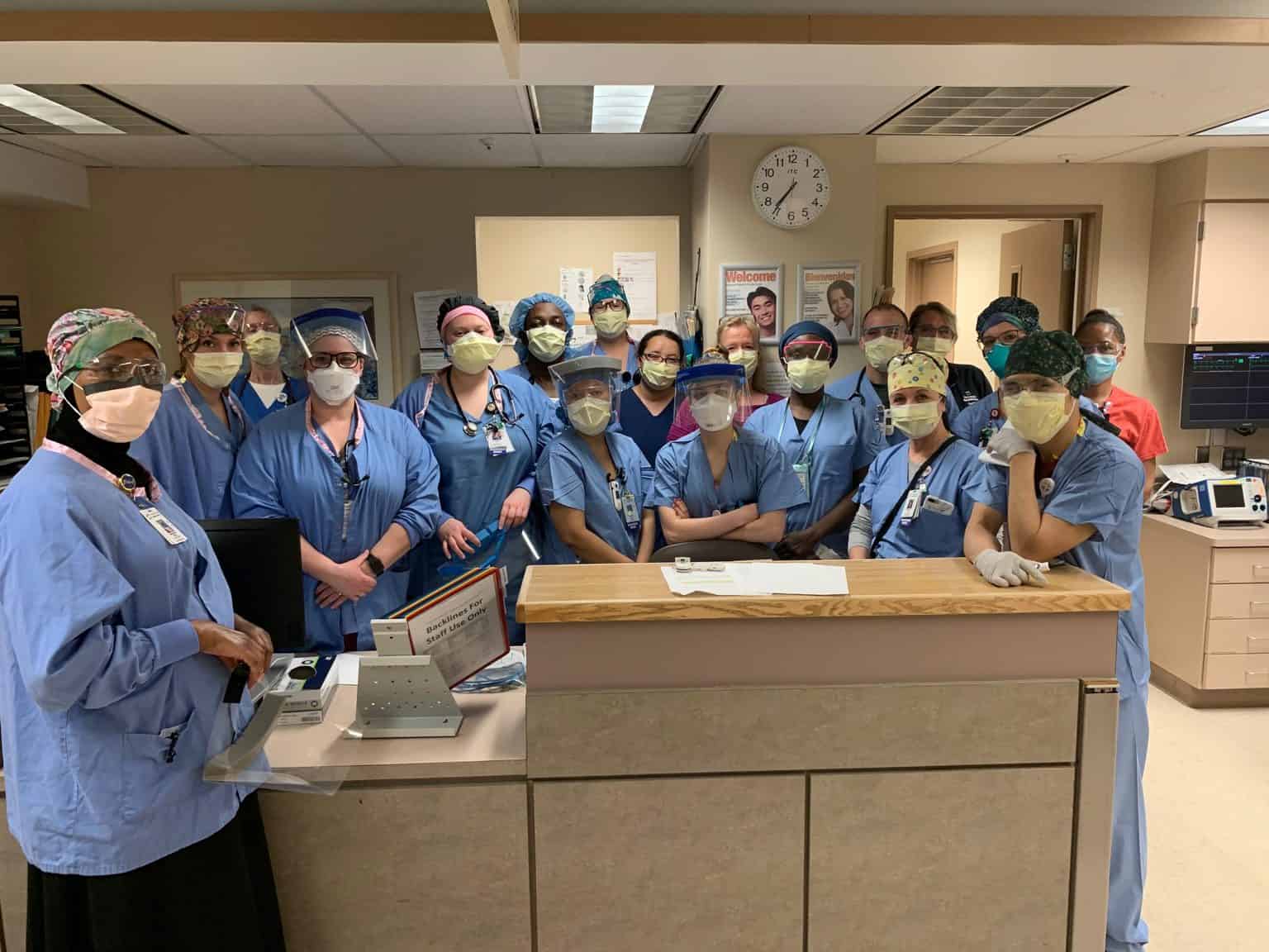 Providers at nurses station wearing masks