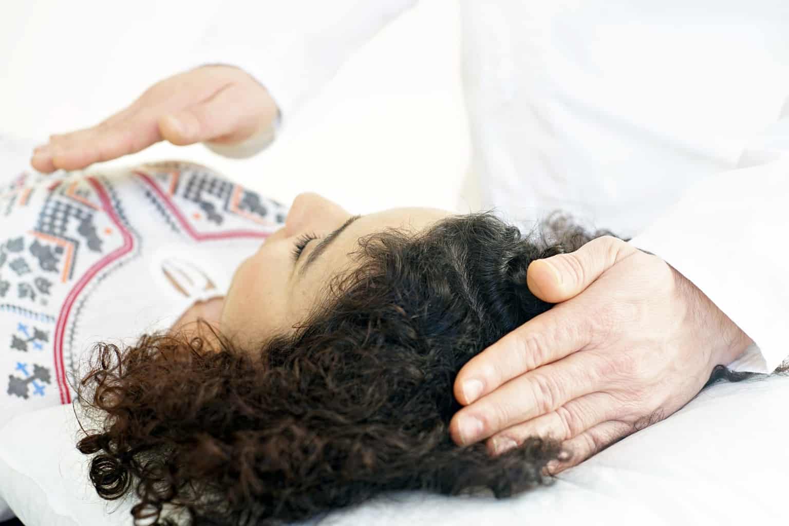 provider pressing top of head of patient
