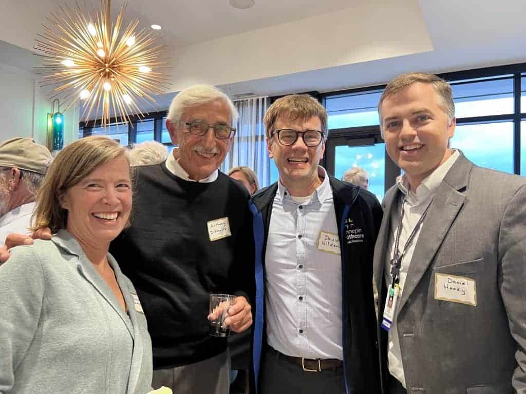 four retired physicians at alumni meeting