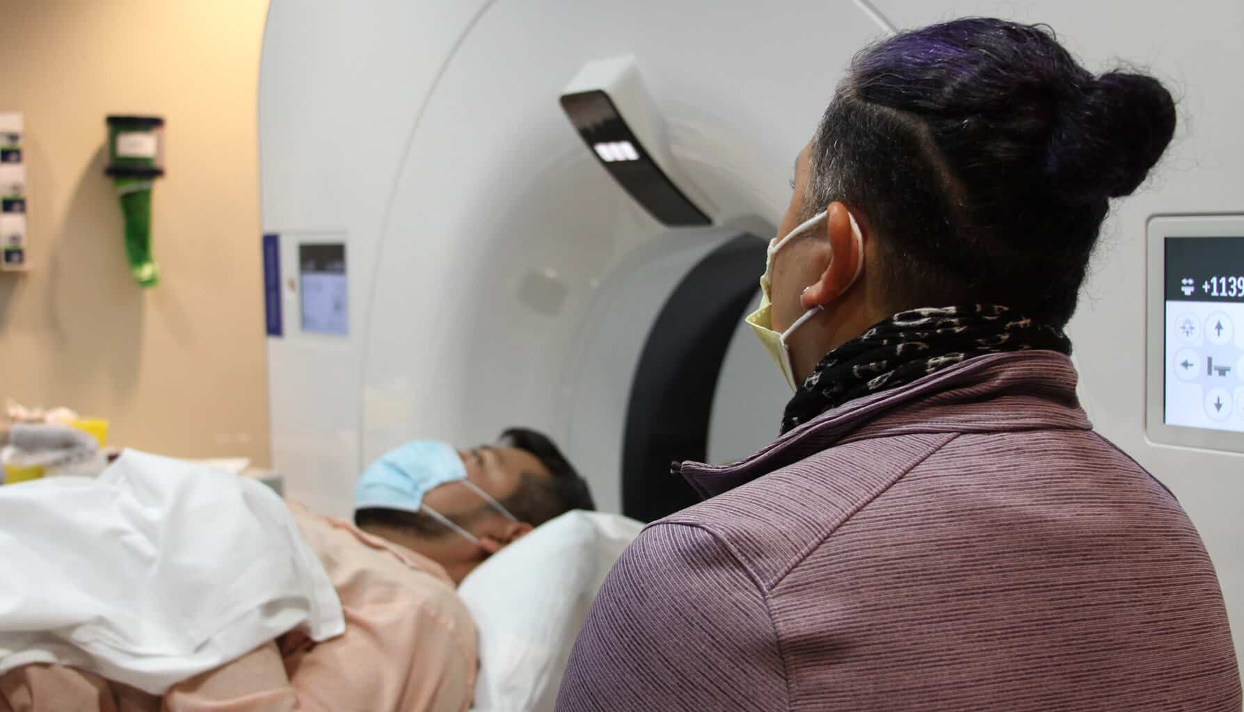 Spanish Interpreter helping translate information for patient from tech during Mri