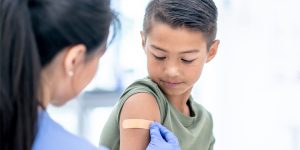 young boy receiving vaccinations from doctor, why are childhood vaccines so important, vaccines protect your child, vaccines protect others, babies are the most vulnerable to illness, herd immunity, dr christine tompkins