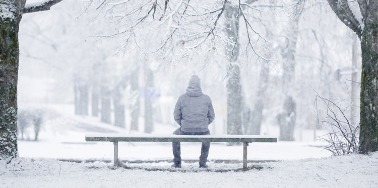 man sitting on bench in winter, grieving during the holidays, the 4 R’s, grief support, respect your own limits, julia rajtar, board certified chaplain