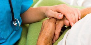 provider holding hand of patient, hospice care, palliative care, comfort care for illness, end of life care, life threatening diseases