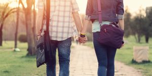 teen couple walking and holding hands outside, let’s talk, ten tips for talking with teens about relationships and sexual health, gender-inclusive language, between us, how to talk to teens about sex, Janna Gewirtz O’Brien