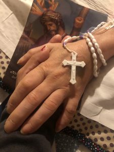 hospice patient holding rosary and loved one's hand, hospice patient, lung disease patient, end of life care, comfort care, palliative care patient