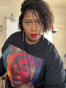 michelle jones wearing a tshirt with one of her paintings, finding your voice, urban expressionist, artist, creating art that affirms, michelle jones