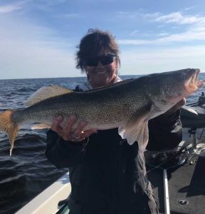 Pam Ruis with walleye, The closest to being cared for is to care for someone else, hospital visit, long term care, home health care nursing, a circle of trust
