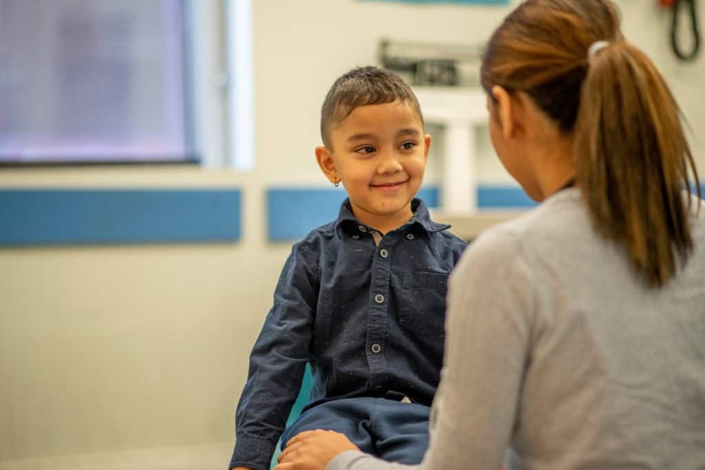 young boy with speech therapist, speech disabilities in children, communication disabilities in children, therapy for childhood language disabilities