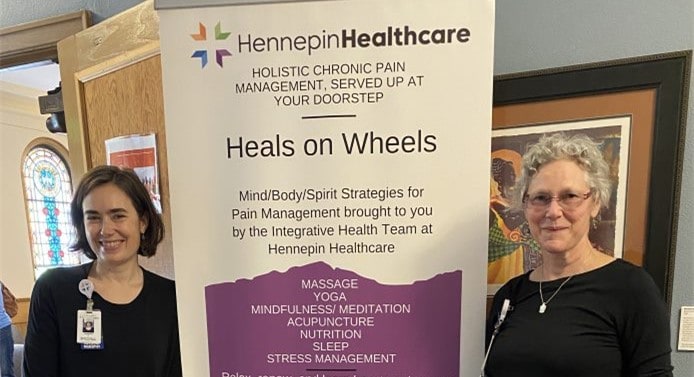 integrative medicine staff holding heals on wheels sign, heals on wheels program, whole person care at home, holistic care at home, integrative care in community