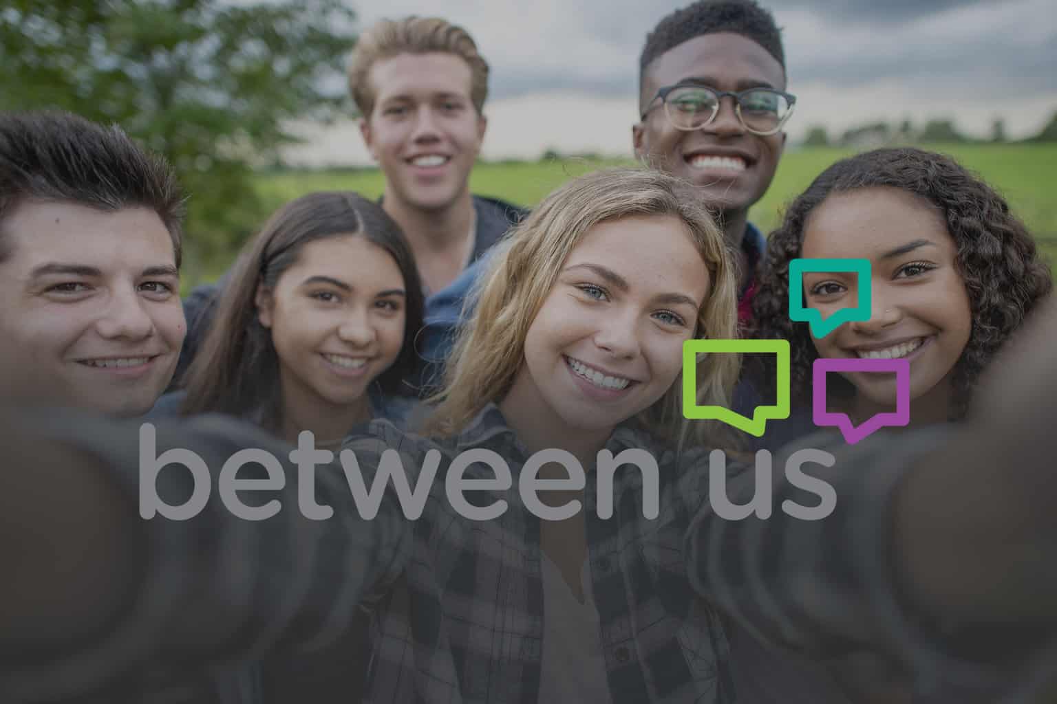 group of teens taking a selfie for between us teen program