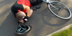 bicyclist fall on asphalt, brain injury awareness month, what to look for when you hit your head, tbi, concussion, red flags of head injuries