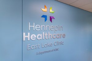 hennepin healthcare east lake clinic logo and sign, east lake clinic, clinic october birthdays, reopened clinic, destruction of original clinic, neighborhood clinic