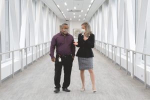 jennifer decubellis walking in skyway with patient, voices of hennepin healthcare, jennifer decubellis, ceo, community needs, planning for future healthcare