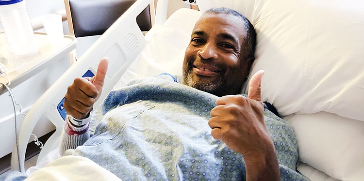 dabney in hospital bed showing two thumbs up after kidney transplant, free from dialysis thanks to kidney that needed a little tlc, hepatitis C-infected kidney, treated for hepatitis C post-transplant, no dialysis needed, kidney transplant, scientific registry of transplant recipients