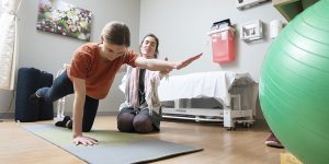 patient with integrative physical therapist doing yoga stretches, integrative pt, integrative physical therapy, myofascial restrictions, craniosacral manual therapy, alternative pt, catherine justice, yoga therapy, holistic stretching