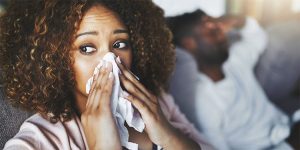 woman sneezing into a tissue, why do females pee when they cough, urine leakage, urinary problems, incontinence in women, Anne Remington, MSN, APRN, CNP, CURN, urologist for women