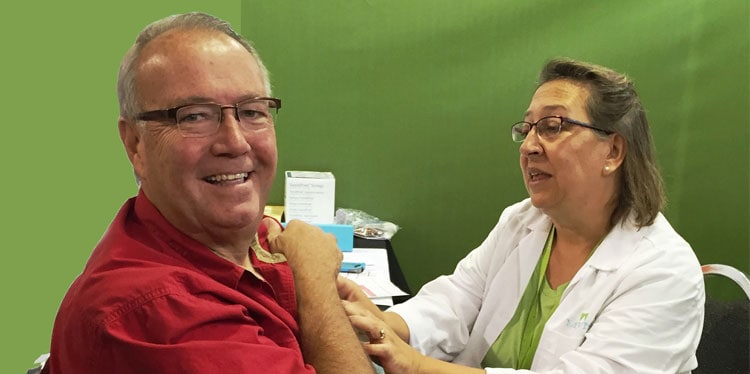 man getting a flu shot by a nurse at the minnesota state fair, hennepin healthcare at the 2018 minnesota state fair, burn center, healthy matters, flu shots, hhc at the fair