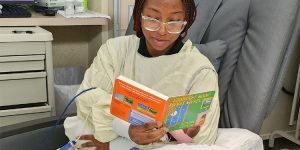 Mikayla Nicu reading a book, neonatal intensive language program, reach out and read, childrens books, read to in their native language, multilingual books