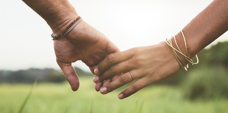 couple holding hands outdoors in a meadow, world sexual health day, safe sexual health experiences, safe sex, consent