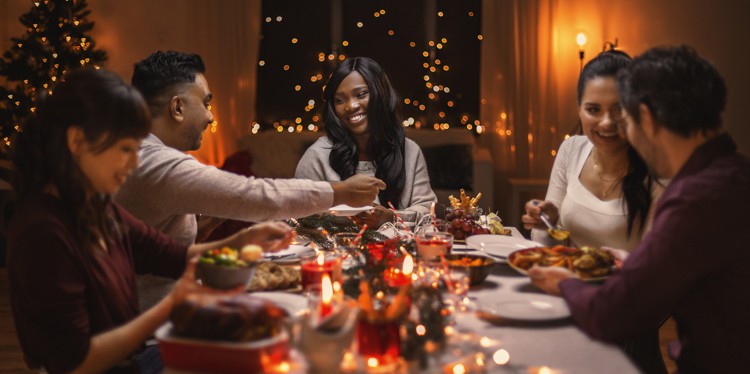 friends gathering for holiday meal, tips for staying healthy during the holidays, holiday flu, holiday covid symptoms, stay healthy during holiday, get vaccinated before the holidays
