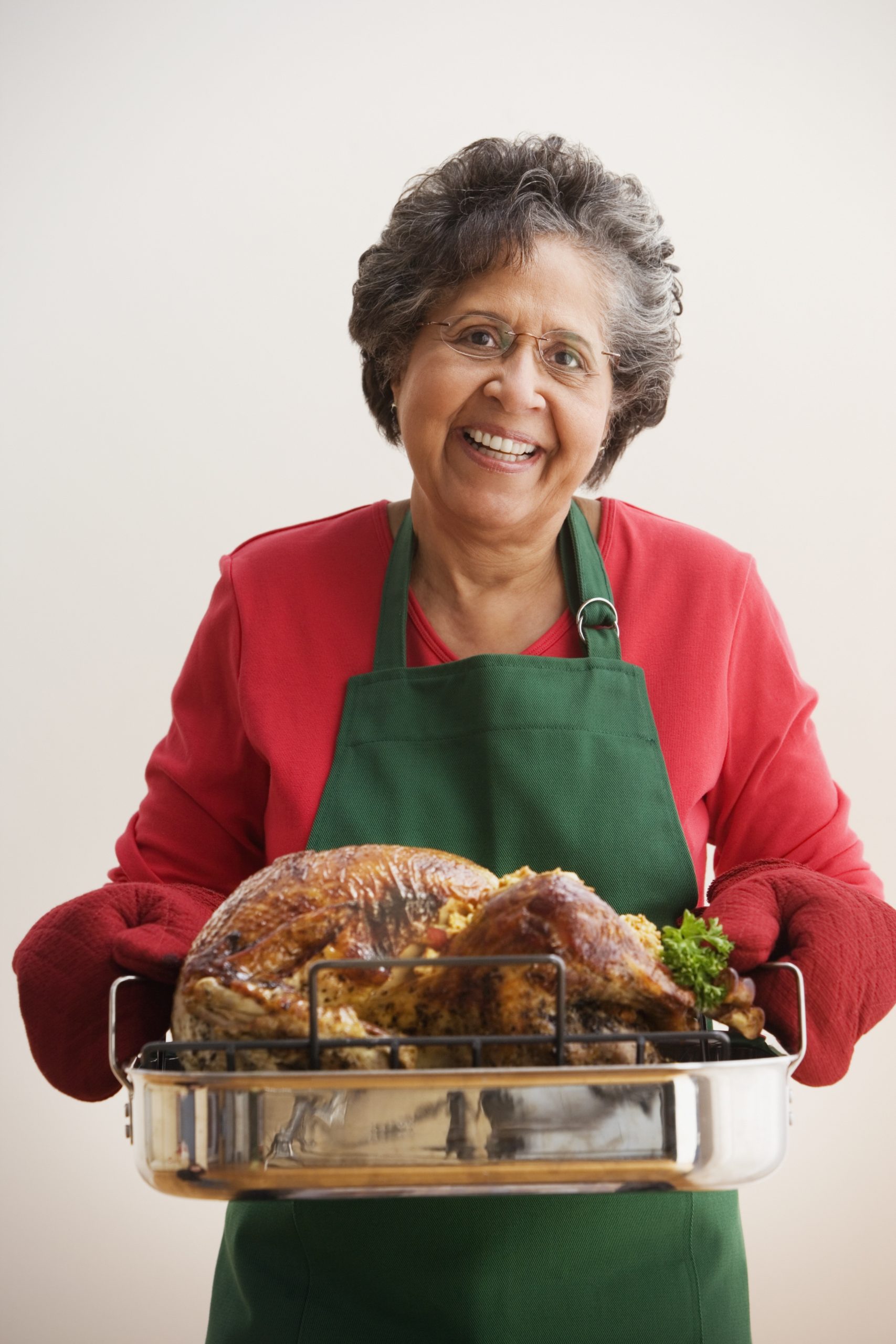 woman holding a cooked turkey, Food prep tips, healthy Thanksgiving meal, Minnesota Poison Control System, prevent food poisoning, food safety tips