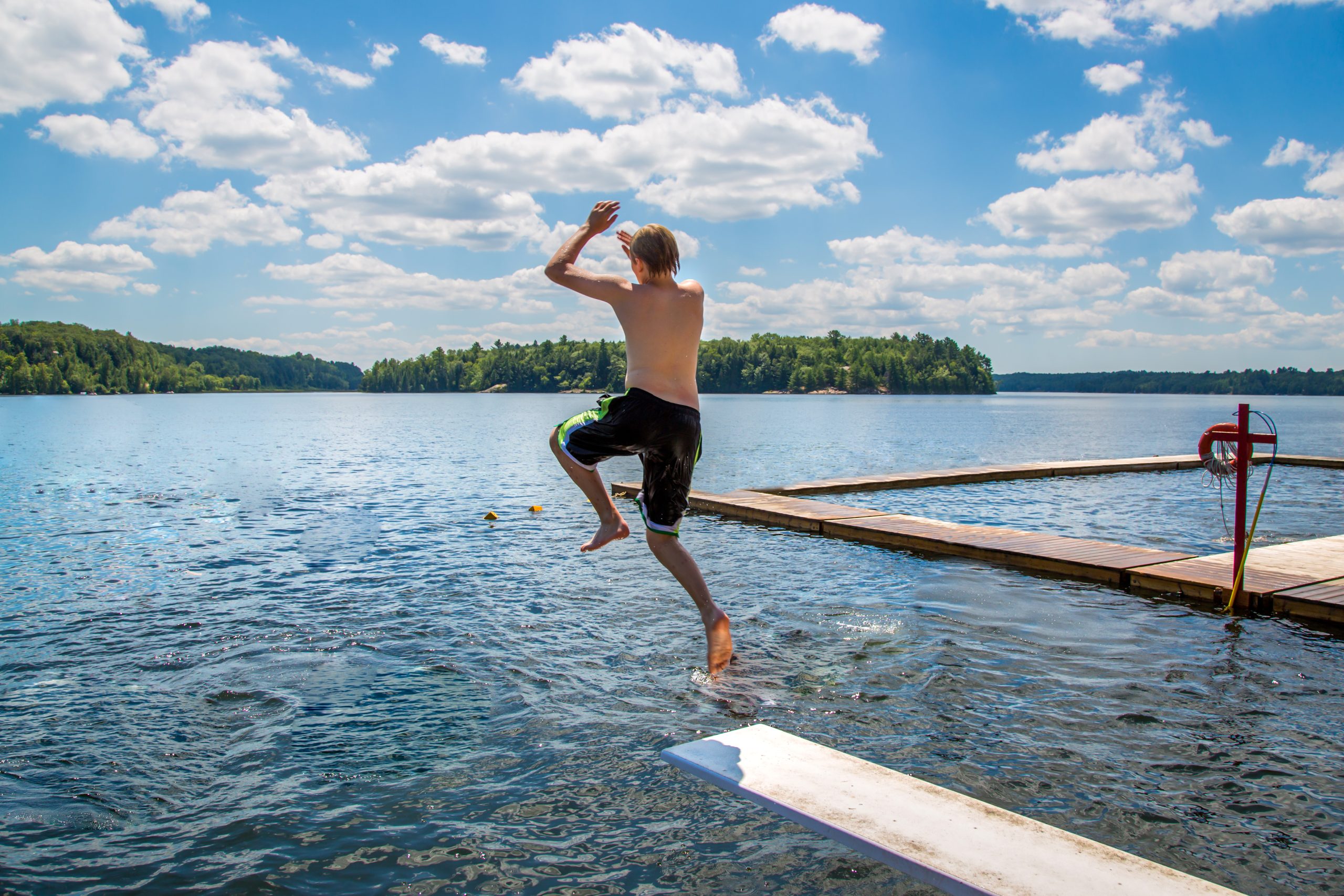 Teenage Boy Jumping in Lake, Hennepin Healthcare trauma experts, diving dangers, trauma season, diving accidents, injury prevention