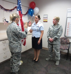 Melissa Conner, RN being sworn in by Lt. Kristi Roers (left) and Major Michelle Lambert
